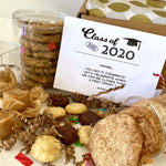 This is a photo showing the delicious treats that come in the box with a personalized graduation card leaning against the box with the gold dot tissue paper in the background.