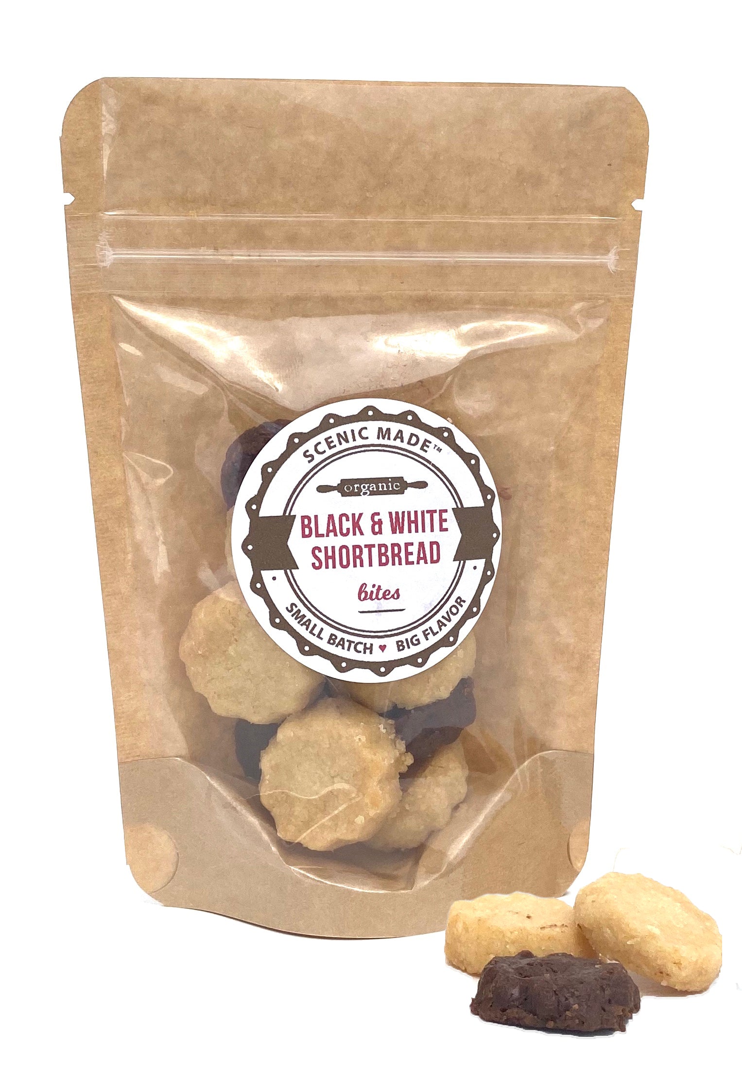 A bag of black and white shortbread bites decorated with gold and silver sparkles.