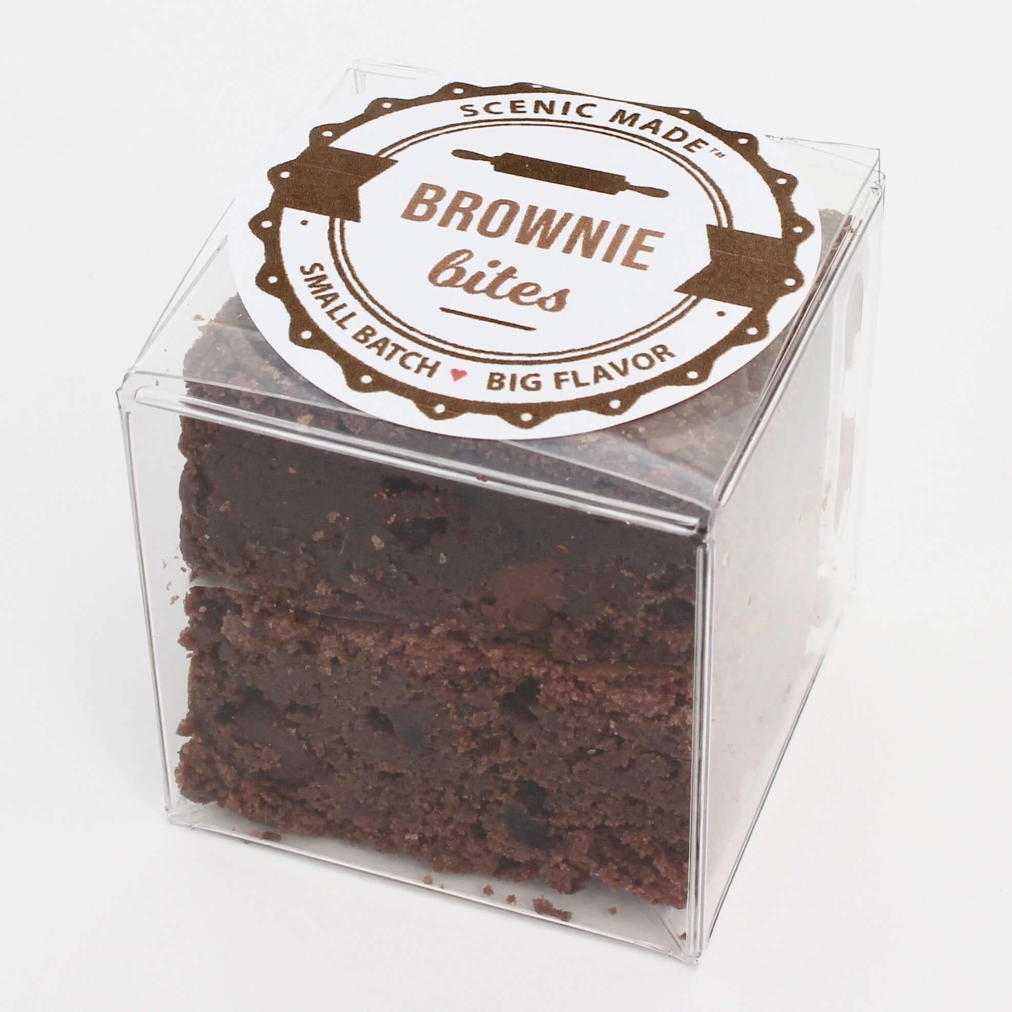  2 decadent brownie bites, packed in a clear, square, food-safe container with an attractive label on top.