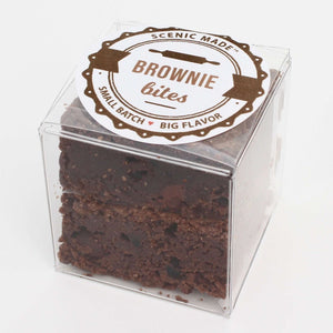  2 decadent brownie bites, packed in a clear, square, food-safe container with an attractive label on top.