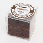 2 decadent brownie bites, packed in a clear, square, food-safe container with an attractive label on top.